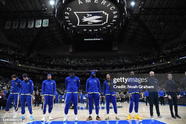 The Golden State Warriors stand for a moment of silence before the game against the Dallas Mavericks Game 4 of the 2022 NBA Playoffs Western...