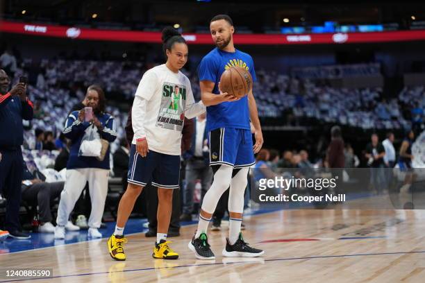 Assistant Coach Kristi Toliver of the Dallas Mavericks talks to Stephen Curry of the Golden State Warriors before Game 4 of the 2022 NBA Playoffs...