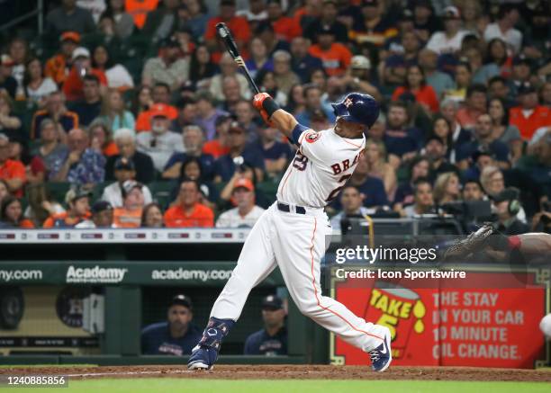 Houston Astros designated hitter Michael Brantley hits a single in the bottom of the fifth inning during the baseball game between the Cleveland...