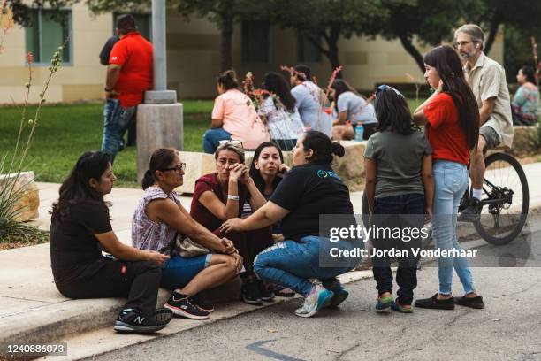 People grieve outside the SSGT Willie de Leon Civic Center, where the community has gathered in the wake of a mass shooting at Robb Elementary School...