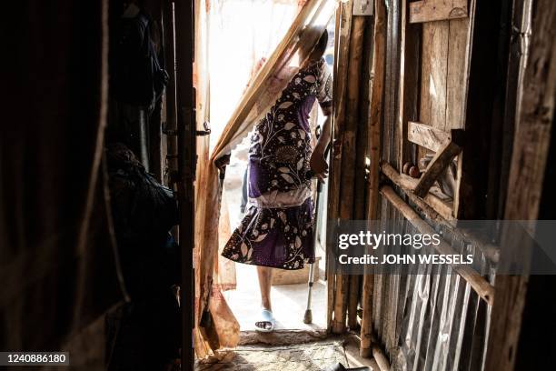 Zainab Turay enters her house in Yams Farm Community on April 15, 2022. - Zainab and her fiancé Lahai Makieu have both lost one of their legs and are...