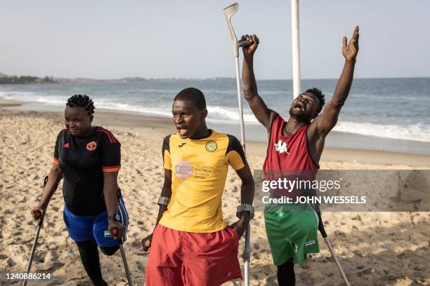 Members of a Single Leg Amputee Sports Association football team break out in song for a new player in Freetown on April 16, 2022. - The Single Leg...