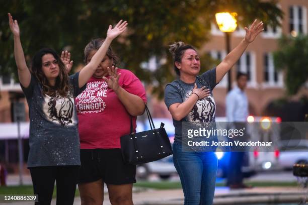 People become emotional at the City of Uvalde Town Square during a prayer vigil in the wake of a mass shooting at Robb Elementary School on May 24,...