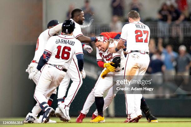 William Contreras of the Atlanta Braves celebrates with teammates after hitting the game-winning RBI during the ninth inning against the Philadelphia...