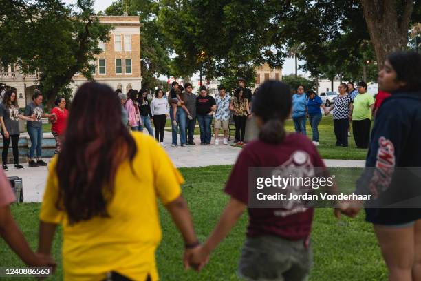 Members of the community gather at the City of Uvalde Town Square for a prayer vigil in the wake of a mass shooting at Robb Elementary School on May...