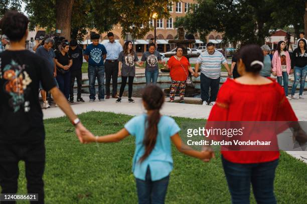 Members of the community gather at the City of Uvalde Town Square for a prayer vigil in the wake of a mass shooting at Robb Elementary School on May...