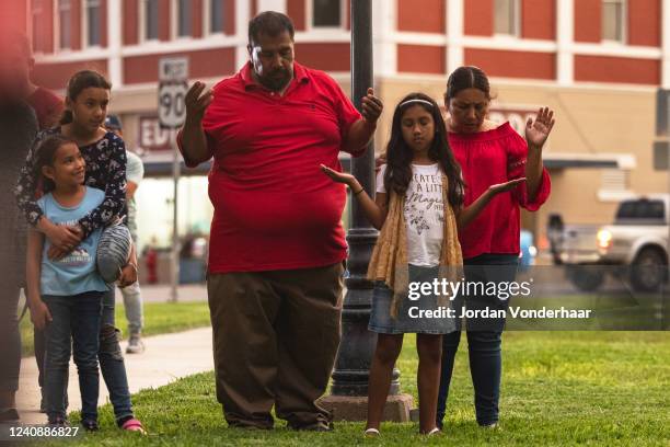 Members of the community gather at the City of Uvalde Town Square for a prayer vigil in the wake of a mass shooting at Robb Elementary School on May...