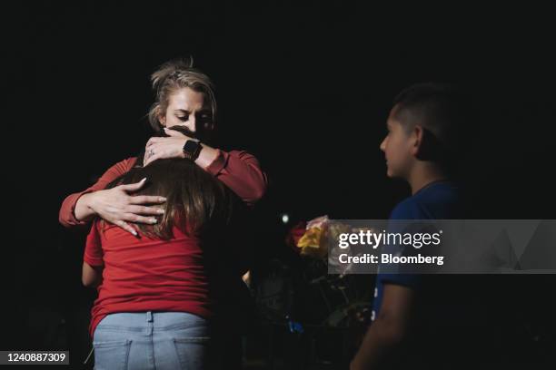 Woman embraces a child outside Willie de Leon Civic Center in Uvalde, Texas, US, on Tuesday, May 24, 2022. President Joe Biden mourned the killing of...