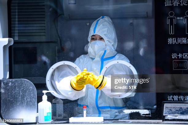 Medical worker prepares to conduct a nucleic acid tests for the Covid-19 coronavirus at a swab collection site in Shenyang in China's northeastern...