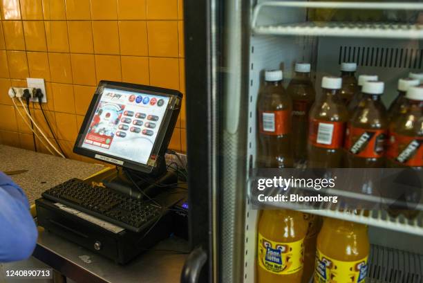 An A2 payment terminal alongside a drinks fridge inside a snack kiosk in the Soweto district of Johannesburg, South Africa, on Wednesday, March 4,...