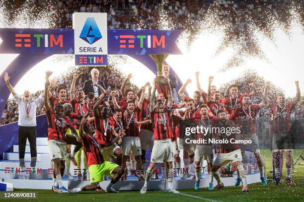 Alessio Romagnoli of AC Milan lifts the Scudetto trophy as players of AC Milan celebrate during the award ceremony following the Serie A football...