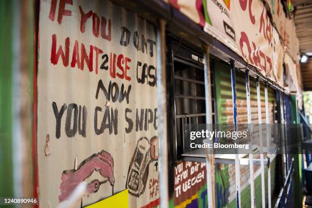 Sign advertising contactless payment outside a convenience store in the Soweto district of Johannesburg, South Africa, on Wednesday, March 4, 2020....