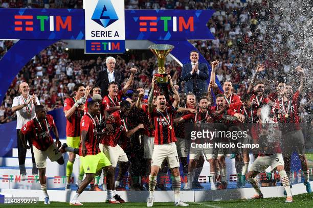 Alessio Romagnoli of AC Milan lifts the Scudetto trophy as players of AC Milan celebrate during the award ceremony following the Serie A football...