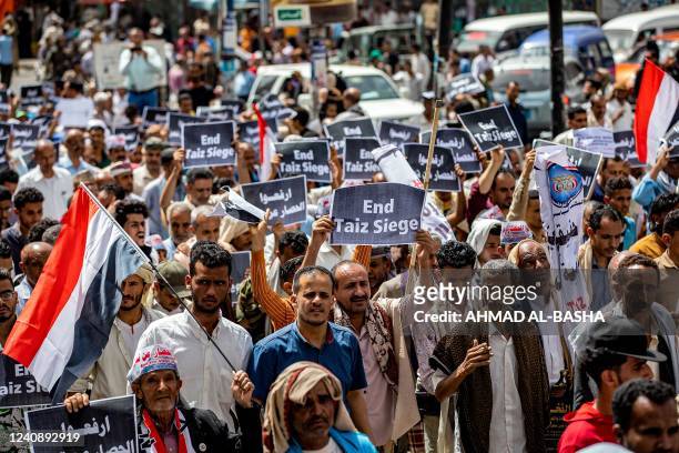 People gather for a demonstration demanding the end of a years-long siege imposed by Yemen's Huthi rebels on their area in the third city of Taez on...