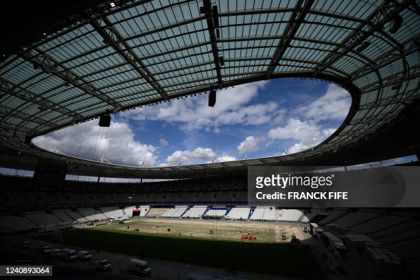 Stade de France staff install a new hybrid pitch at the Stade de France, in Saint-Denis, outside Paris, on May 24, 2022. - Within 48 hours, a new...