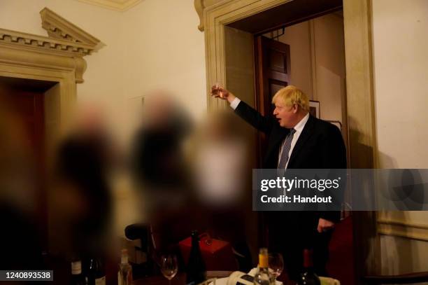 In this handout photo taken on 13 November 2020; Prime Minister Boris Johnson is seen holding a drink at a gathering in 10 Downing Street on the...