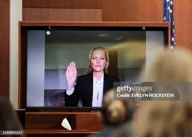 Model Kate Moss is sworn in via video link at the Fairfax County Circuit Courthouse in Fairfax, Virginia, on May 25, 2022. - Actor Johnny Depp is...