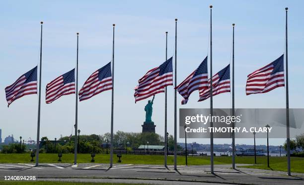 Flags, across New York Bay from the Statue of Liberty, fly at half-mastat Liberty State Park in Jersey City, New Jersey, on May 25 as a mark of...