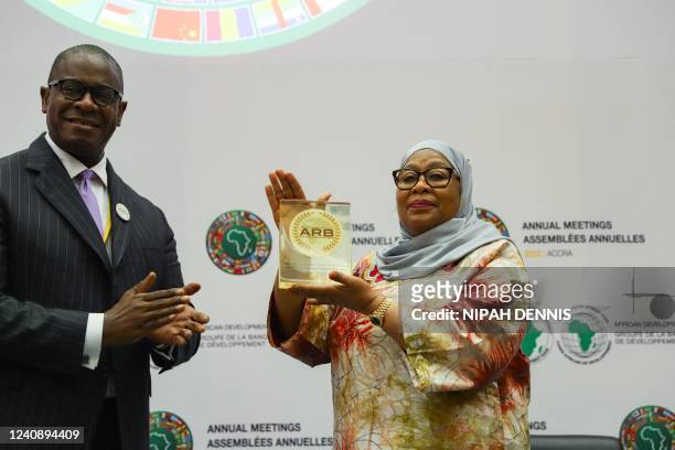 Samia Suluhu Hassan , President of Tanzania, receives from Solomon Quaynor, Vice President of the Private Sector and Industrialization of the African...