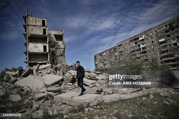 Man walks past a damaged building after a strike in Kramatorsk in the eastern Ukranian region of Donbas, on May 25, 2022.