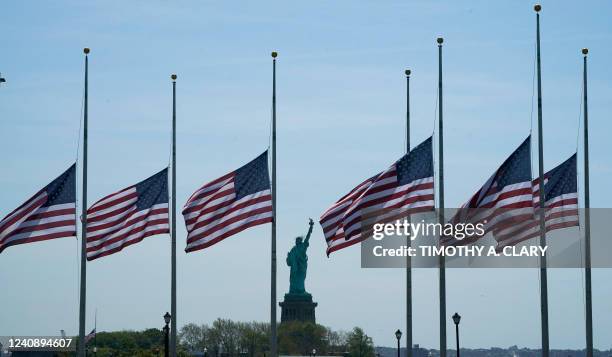 Flags, across New York Bay from the Statue of Liberty, fly at half-mastat Liberty State Park in Jersey City, New Jersey, on May 25 as a mark of...