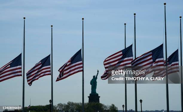 Flags, across New York Bay from the Statue of Liberty, fly at half-mastat Liberty State Park in Jersey City, New Jersey, on May 25 as a mark of...