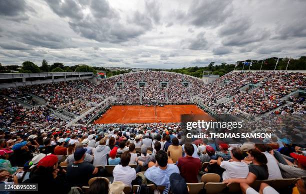 Spectators watch the men's singles match between Serbia's Novak Djokovic and Slovakia's Alex Molcan at the Court Suzanne-Lenglen on day four of the...