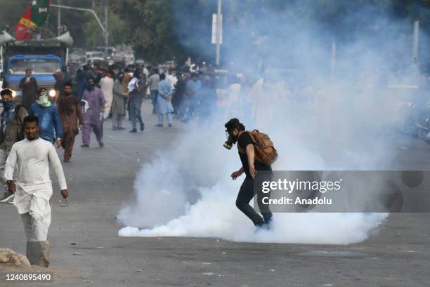 Pakistani police use teargas shells against Pakistan Tehreek-e-Insaf protesters at Faizabad interchange in Karachi, Pakistan on May 25, 2022.