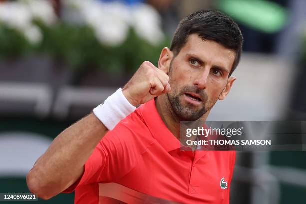 Serbia's Novak Djokovic celebrates after winning against Slovakia's Alex Molcan at the end of their men's singles match on day four of the...