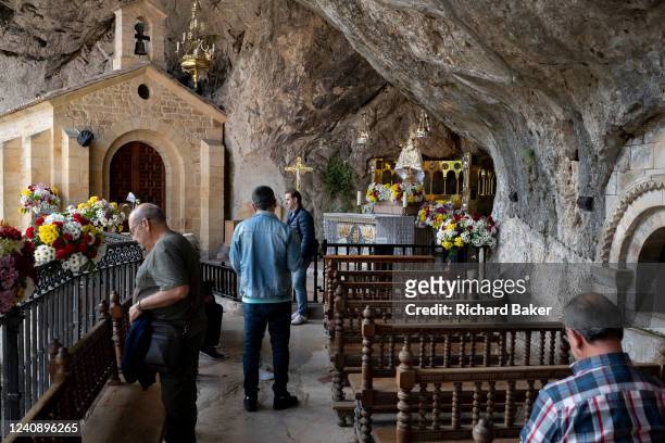 Faithful Christians visit the Santa Cueva de Nuestra Señora de Covadonga , a Catholic cliff face sanctuary, on 16th May 2022, in Vovadonga, Picos...