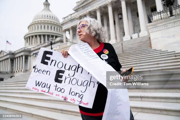 Cindy Nell of Prince Georges County, Md., holds a list of school shootings since 1998 during a demonstration with Moms Demand Action for Gun Sense in...