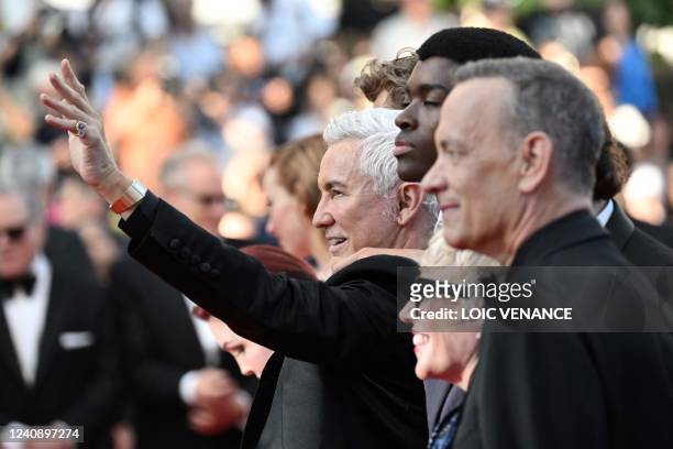 Australian director Baz Luhrmann arrives with cast members for the screening of the film "Elvis" during the 75th edition of the Cannes Film Festival...