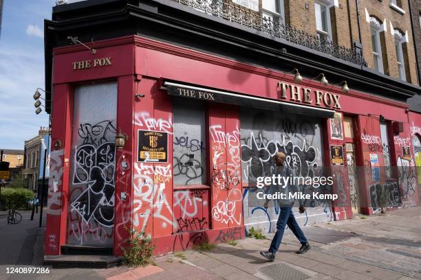 Graffiti covered closed down pub The Fox in Haggerston on 19th May 2022 in London, United Kingdom. Due to changing habits of drinkers, the economic...