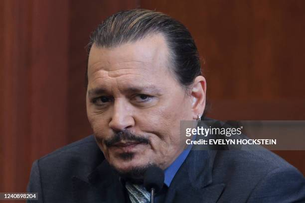 Actor Johnny Depp reacts as he testifies in the courtroom during his defamation trial against his ex-wife Amber Heard, at the Fairfax County Circuit...