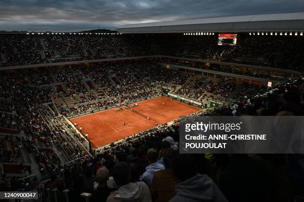 Spectators watch France's Corentin Moutet playing against Spain's Rafael Nadal during their men's singles match on day four of the Roland-Garros Open...