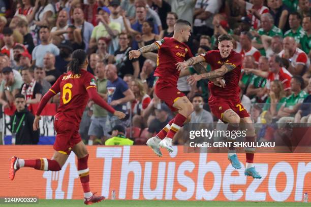 Roma's Italian midfielder Nicolo Zaniolo celebrates with teammates after scoring the opening goal during the UEFA Europa Conference League final...