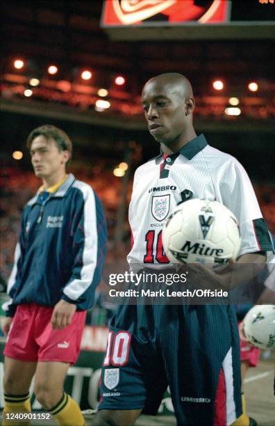 September 1997 Wembley - FIFA Qualifying Match - England v Moldova - Ian Wright of England carrying a Mitre ball.