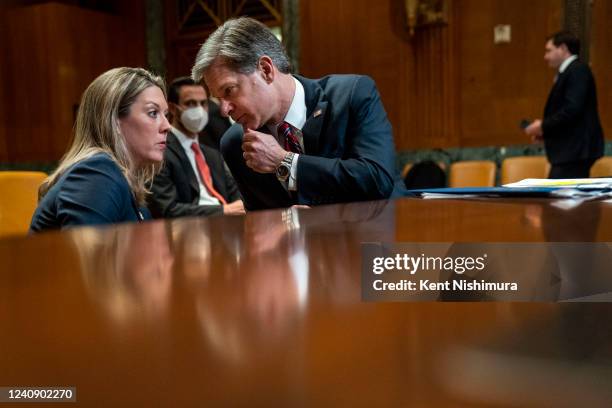 Director Christopher Wray confers with a staffer before the start of a Senate Appropriations subcommittee on Commerce, Justice, Science, and Related...