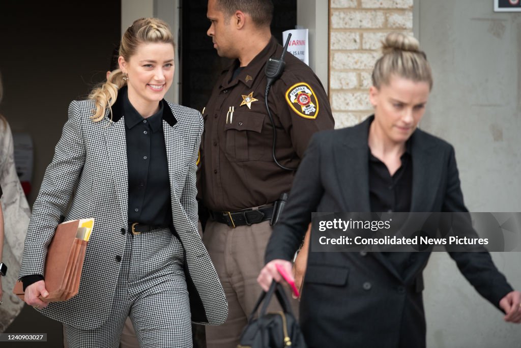 Amber Heard, left, and her sister Whitney Heard, depart at the close