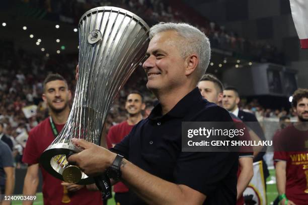 Roma's Portuguese head coach Jose Mourinho with the trophy after winning the UEFA Europa Conference League final football match between AS Roma and...