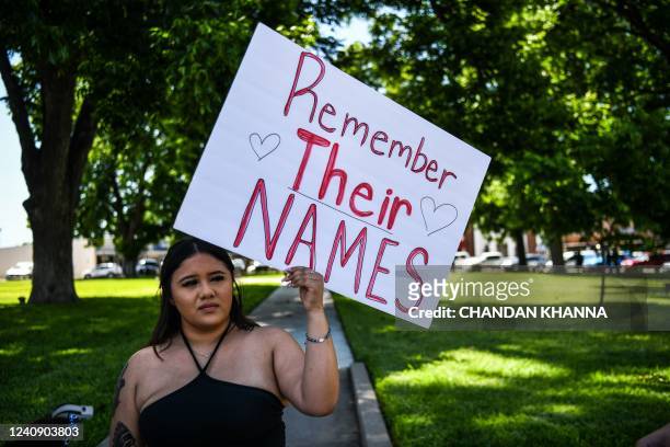 Local resident holds a placard that reads Prayers 4 Uvalde as they grieve for the victims of the mass shooting at Robb Elementary School in Uvalde,...