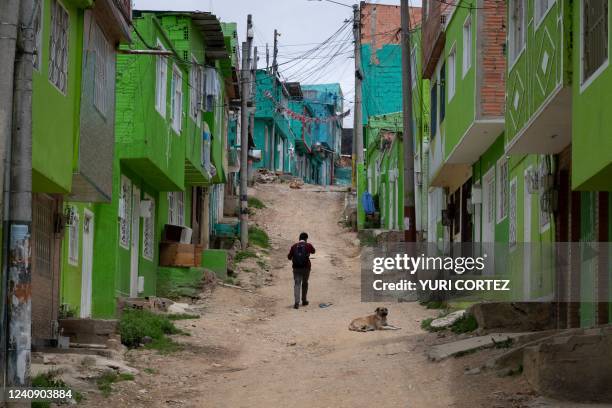 Boy walks along a street in Ciudad Bolivar, Bogota, on May 25 days ahead of presidential elections. - Ciudad Bolivar is one of the most populous mega...