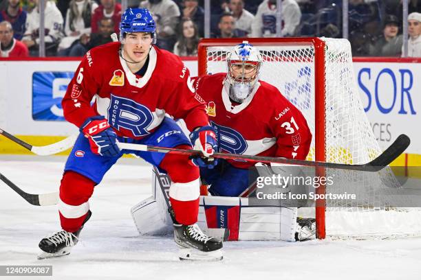 Laval Rocket goalie Cayden Primeau tracks the play beside Laval Rocket defenceman Corey Schueneman during the game 2 of round 3 of the Calder Cup...