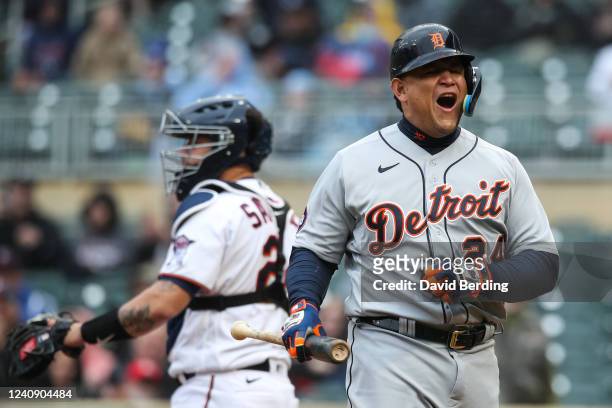 Miguel Cabrera of the Detroit Tigers reacts to looking at a called third strike while Gary Sanchez of the Minnesota Twins looks on in the ninth...