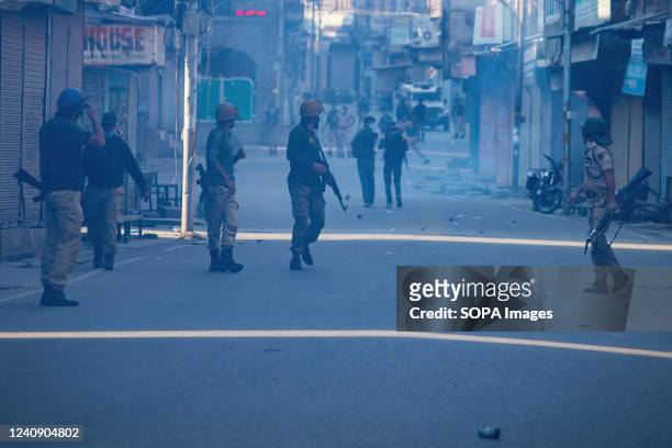 Indian policemen patrol the street during a protest against the sentencing of Kashmiri separatist leader Yasir Malik. Indian court sentenced the...