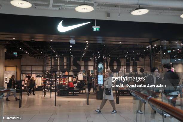 People walk near the entrance to Nike store, May 25, 2022 in Moscow, Russia. Nike Inc. With its 116 Russian stores and British retailer Marks and...