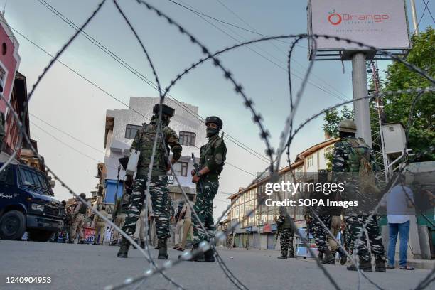 Paramilitary troopers stand alert during a protest against sentencing of Kashmiri separatist leader Yasin Malik. An Indian court has sentenced the...