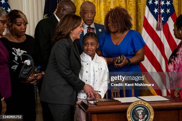 Vice President Kamala Harris and Gianna Floyd, daughter of George Floyd, share a moment after President Joe Biden signed an executive order to...