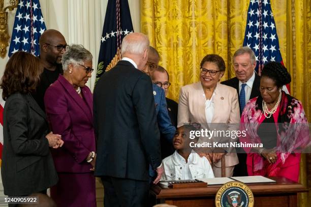 Gianna Floyd looks at the signed executive order to advance policing and strengthen public safety as President Joe Biden looks at her in the East...