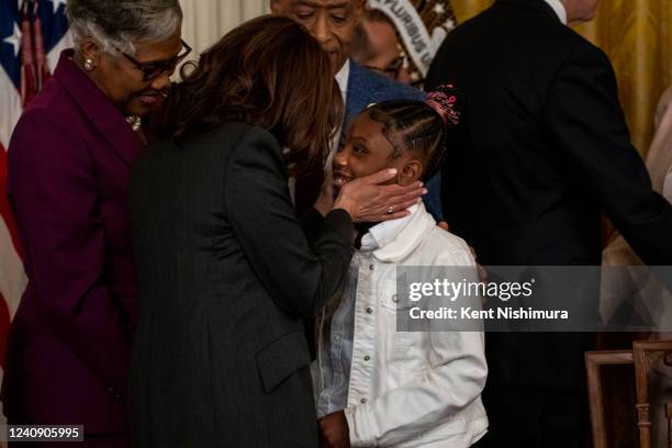 Vice President Kamala Harris talks with Gianna Floyd, daughter of George Floyd, after President Joe Biden signed an executive order to advance...